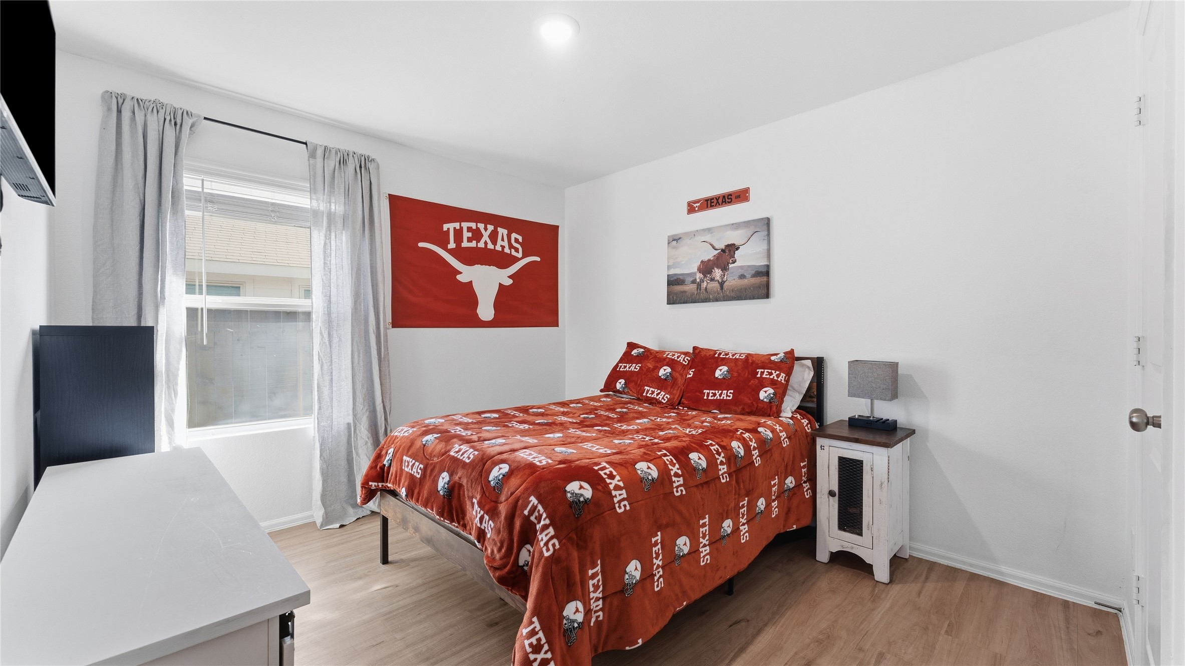 126 Spring Rose Drive Magnolia, TX 77354 - Photo 35 of 48 a bedroom with a bed and wooden floor