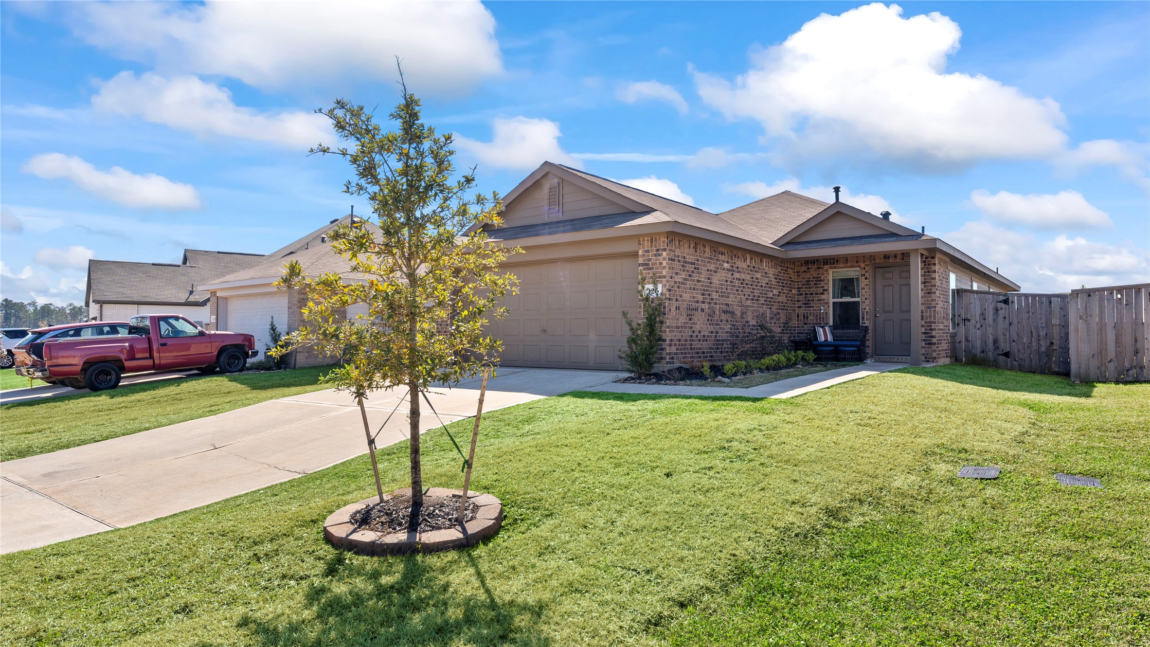 126 Spring Rose Drive Magnolia, TX 77354 - Photo 5 of 48 a house view with a garden space