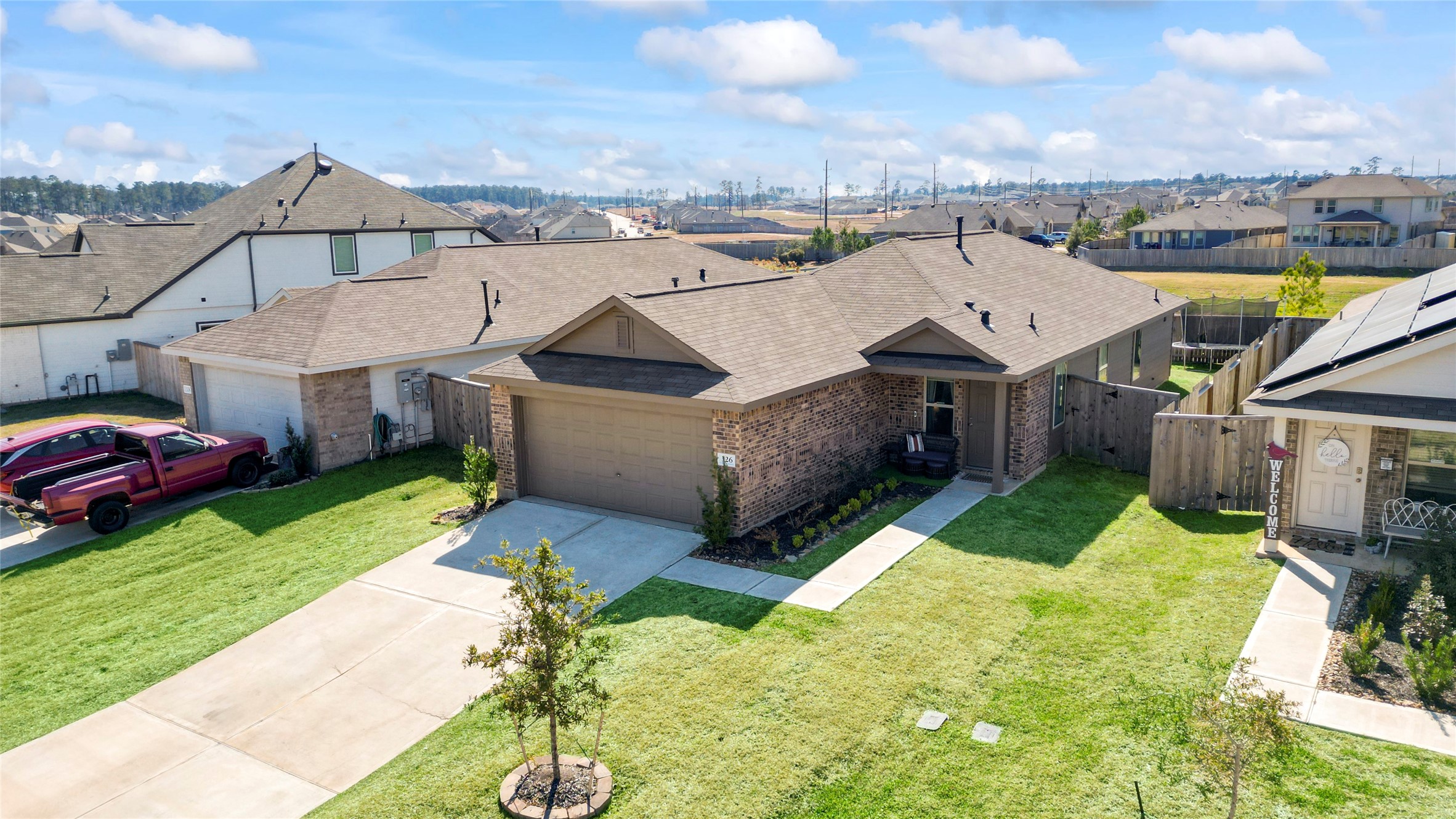 126 Spring Rose Drive Magnolia, TX 77354 - Photo 8 of 48 a view of a house with a big yard plants and large tree