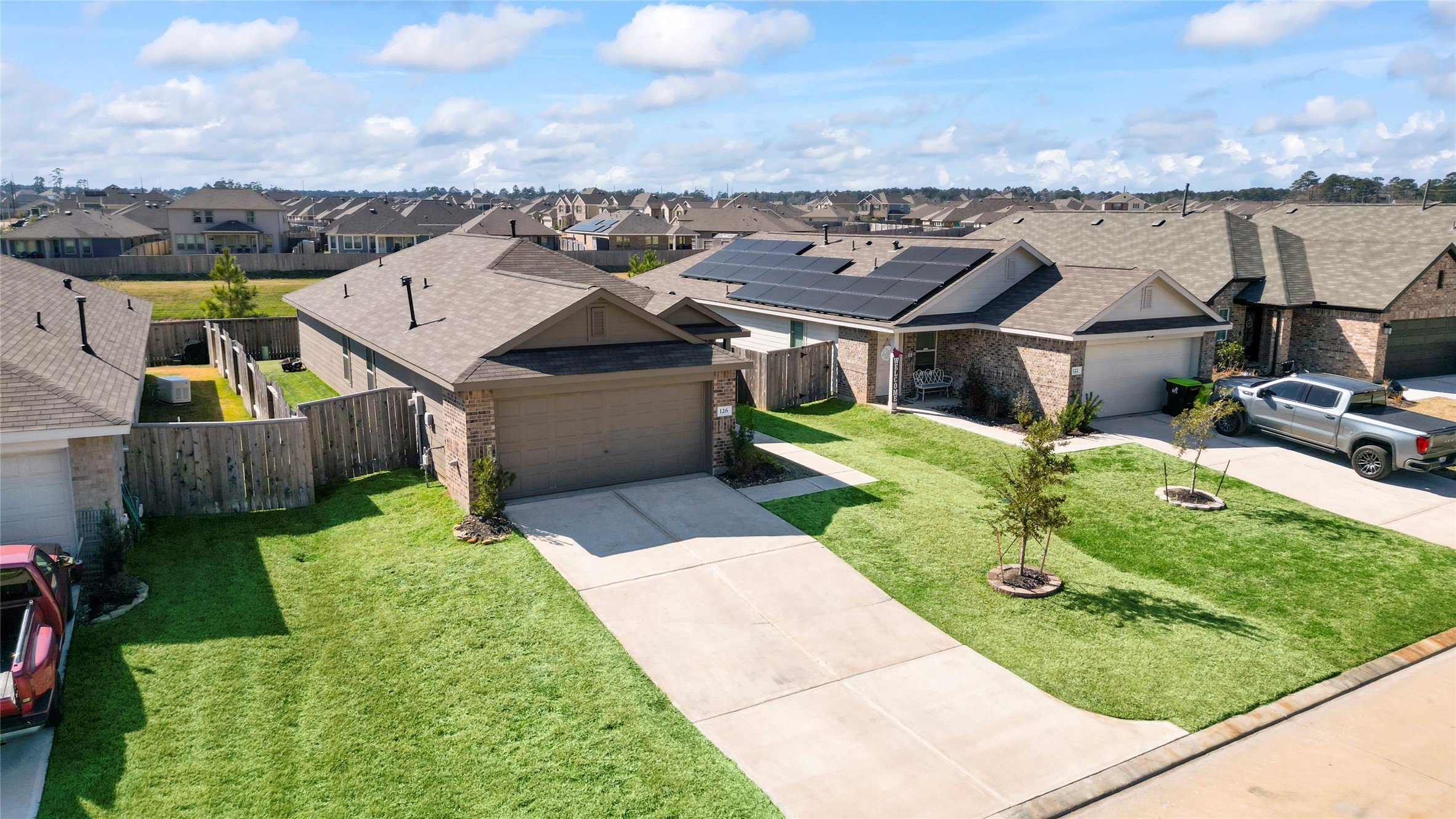 126 Spring Rose Drive Magnolia, TX 77354 - Photo 9 of 48 an aerial view of a house with a garden and a yard