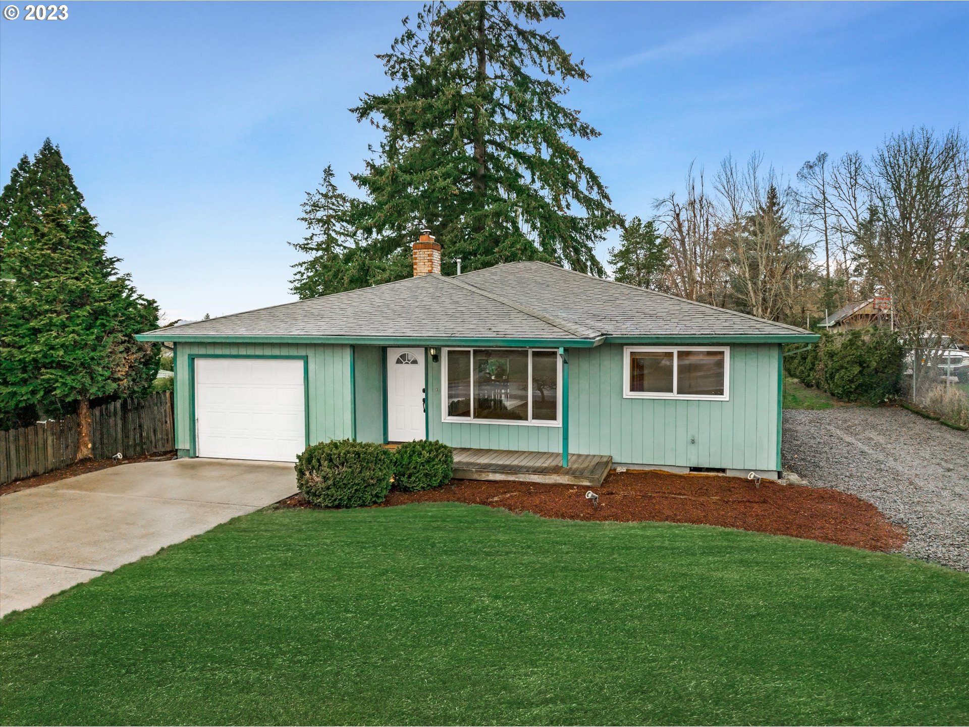 4011 Southeast View Acres Road Milwaukie, OR 97267 - Photo 5 of 19 a front view of a house with a garden