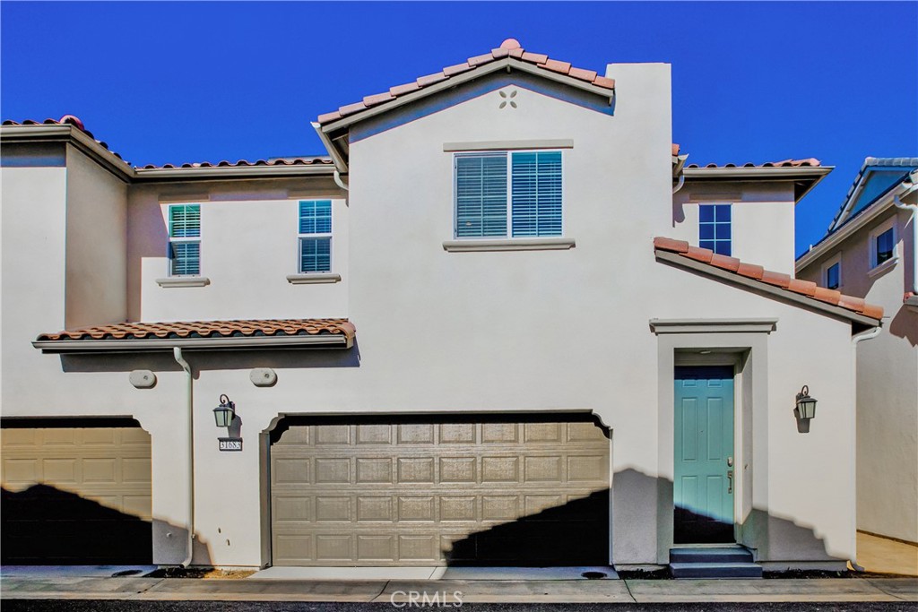 a front view of a house with garage