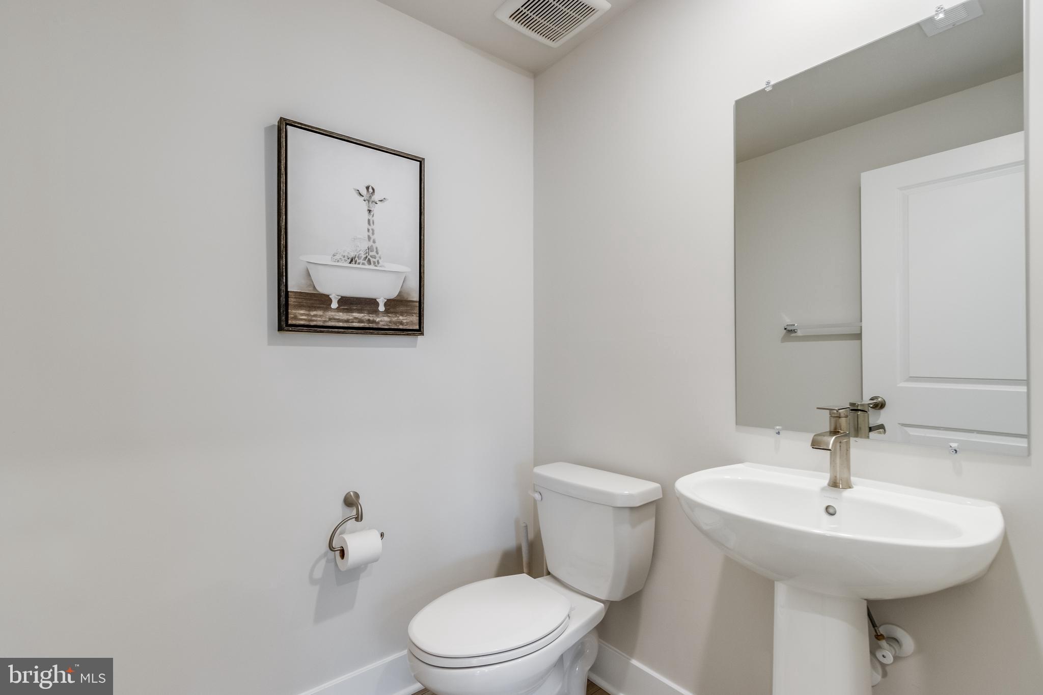 31325 Taywood Drive, Unit TH50 Frankford, DE 19945 - Photo 11 of 31 a bathroom with a toilet a sink and mirror