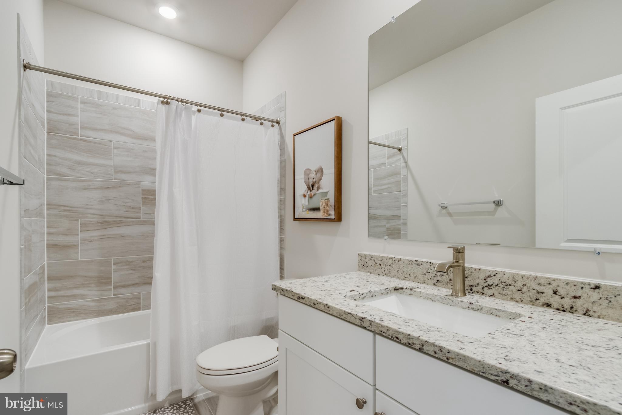 31325 Taywood Drive, Unit TH50 Frankford, DE 19945 - Photo 25 of 31 a bathroom with a granite countertop sink a toilet and shower