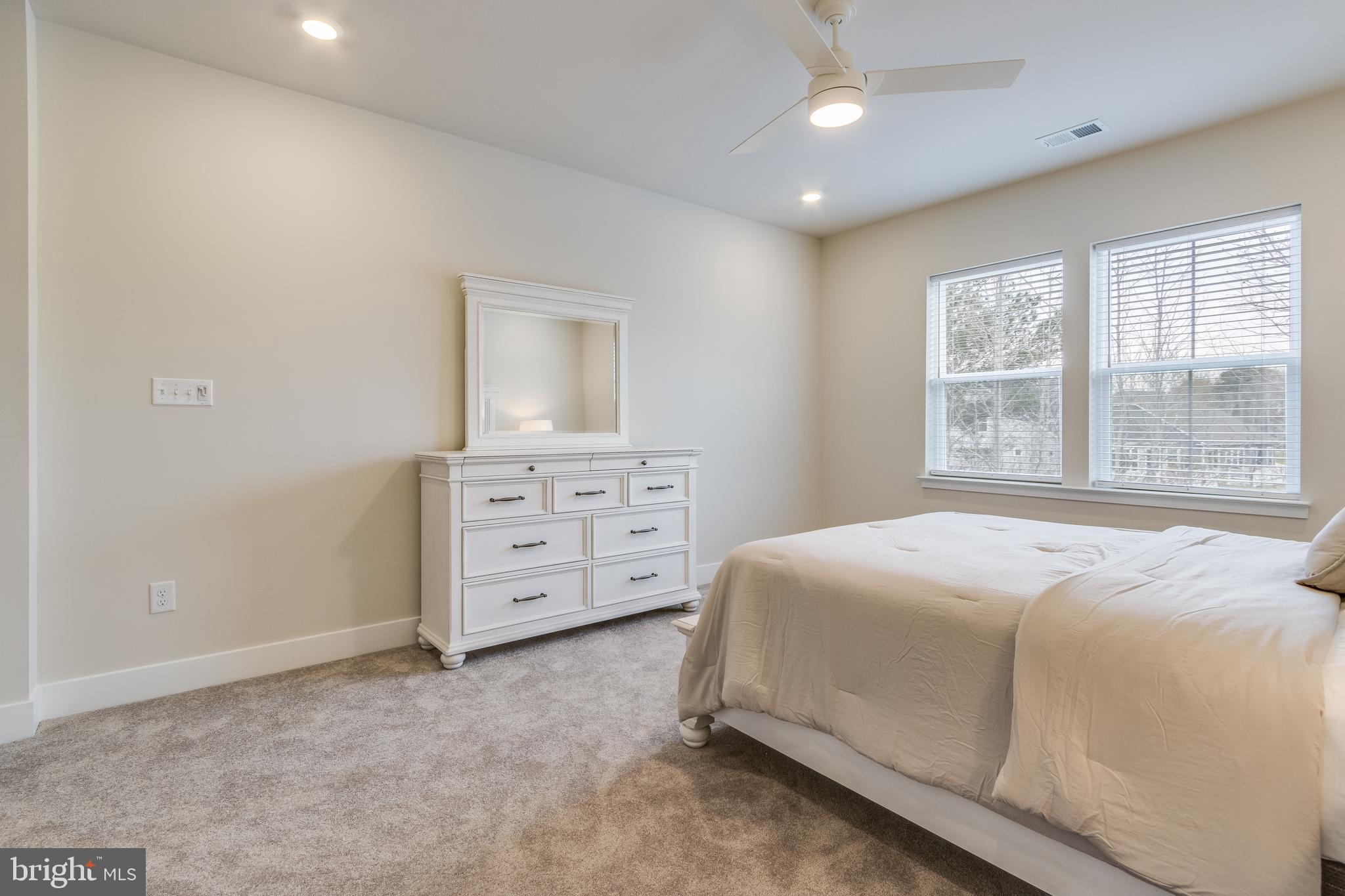 31325 Taywood Drive, Unit TH50 Frankford, DE 19945 - Photo 30 of 31 a spacious bedroom with a bed and a cabinets