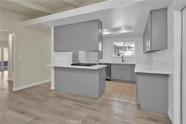 a kitchen with granite countertop a sink and a stove top oven