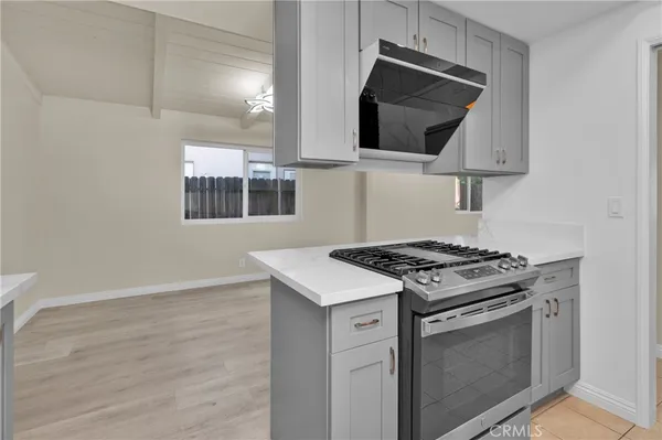 a kitchen with cabinets and a stove top oven