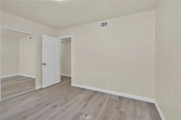 an empty room with wooden floor