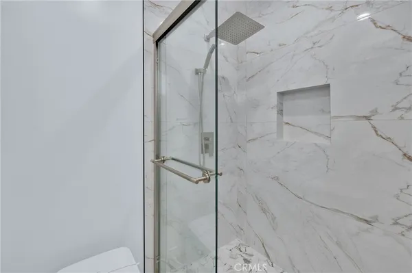 a bathroom with a glass shower door