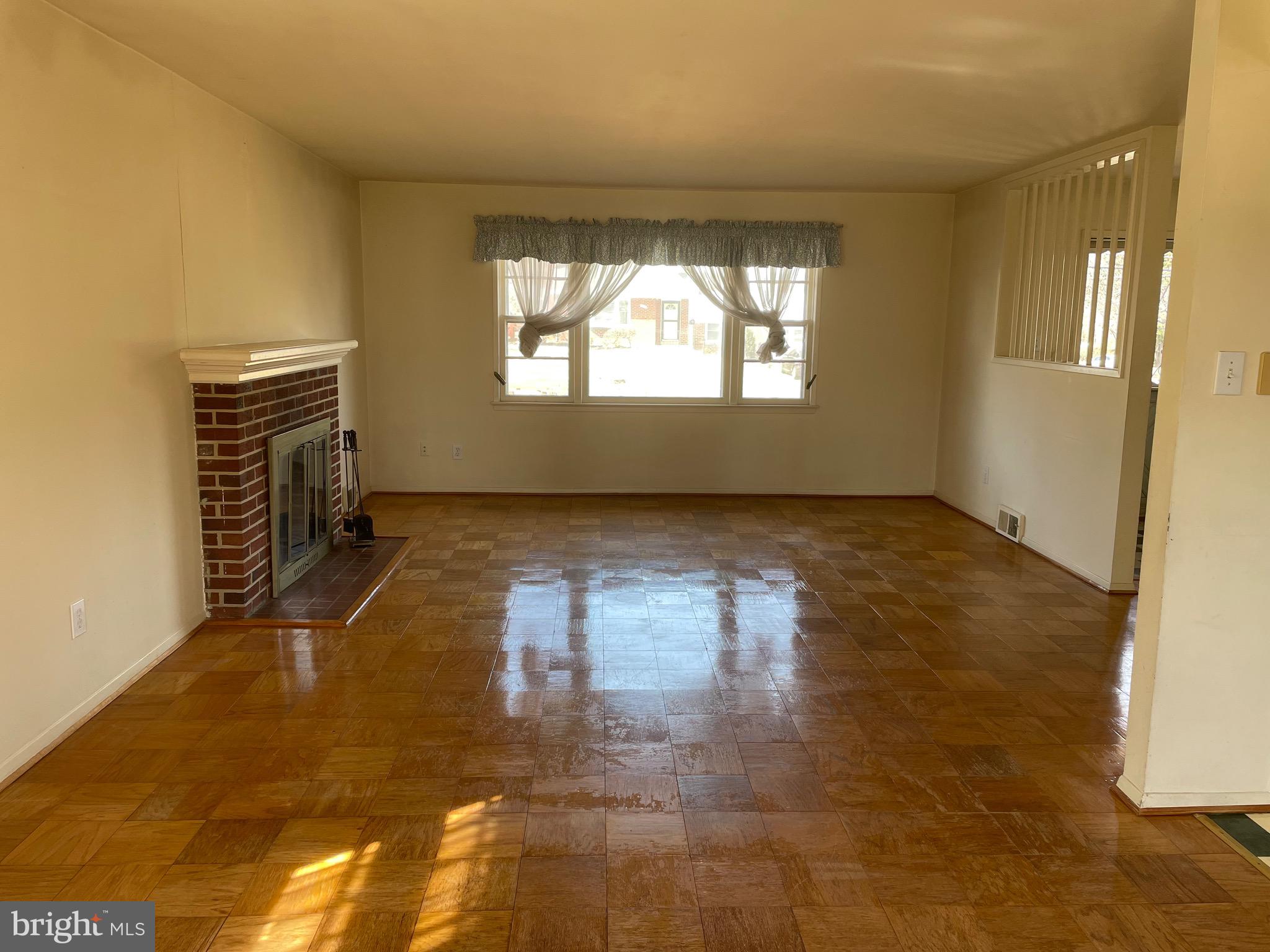5409 Montgomery Street Springfield, VA 22151 - Photo 4 of 8 a view of empty room with wooden floor and fan