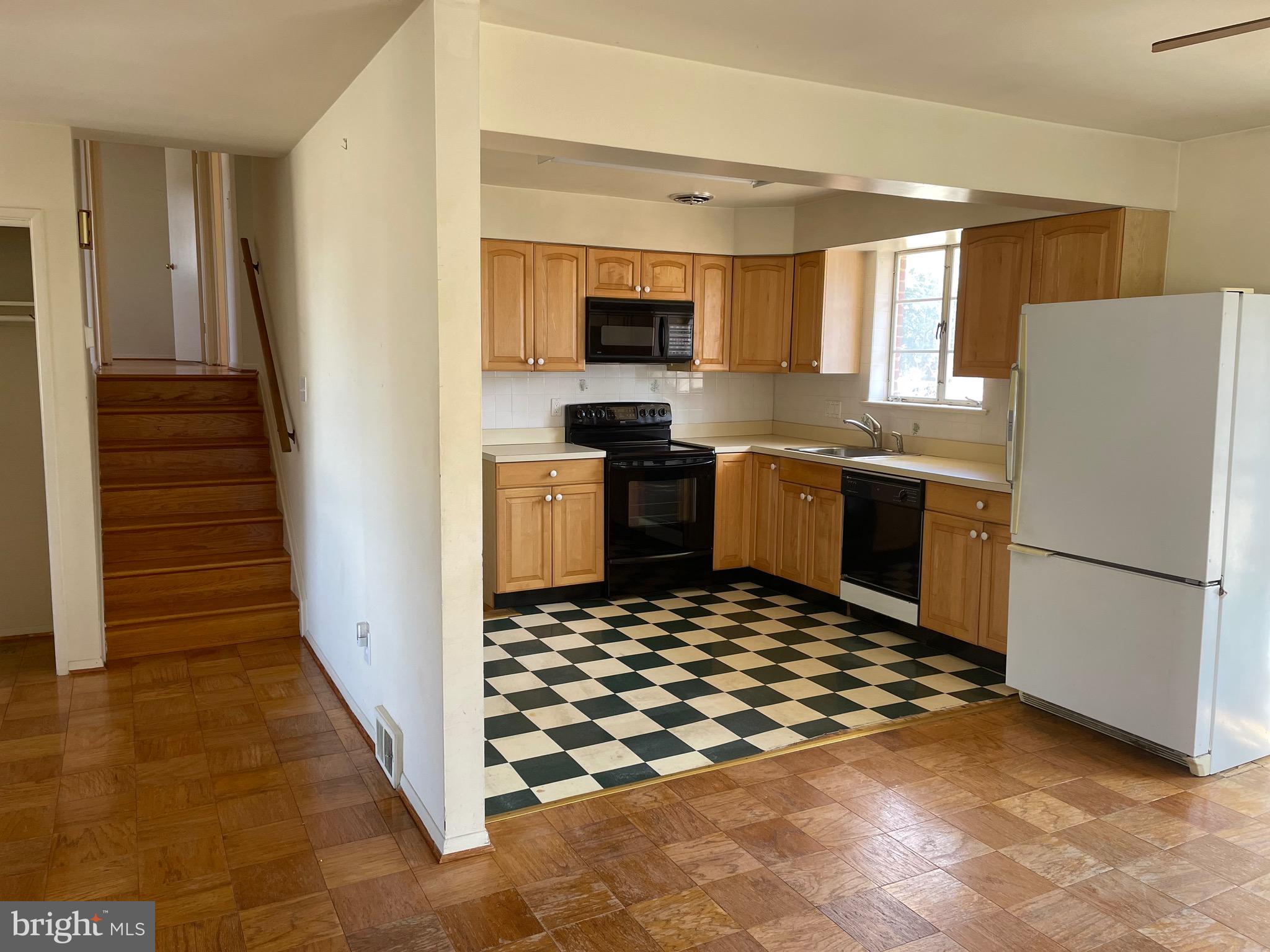 5409 Montgomery Street Springfield, VA 22151 - Photo 5 of 8 a kitchen with granite countertop a refrigerator and a stove top oven