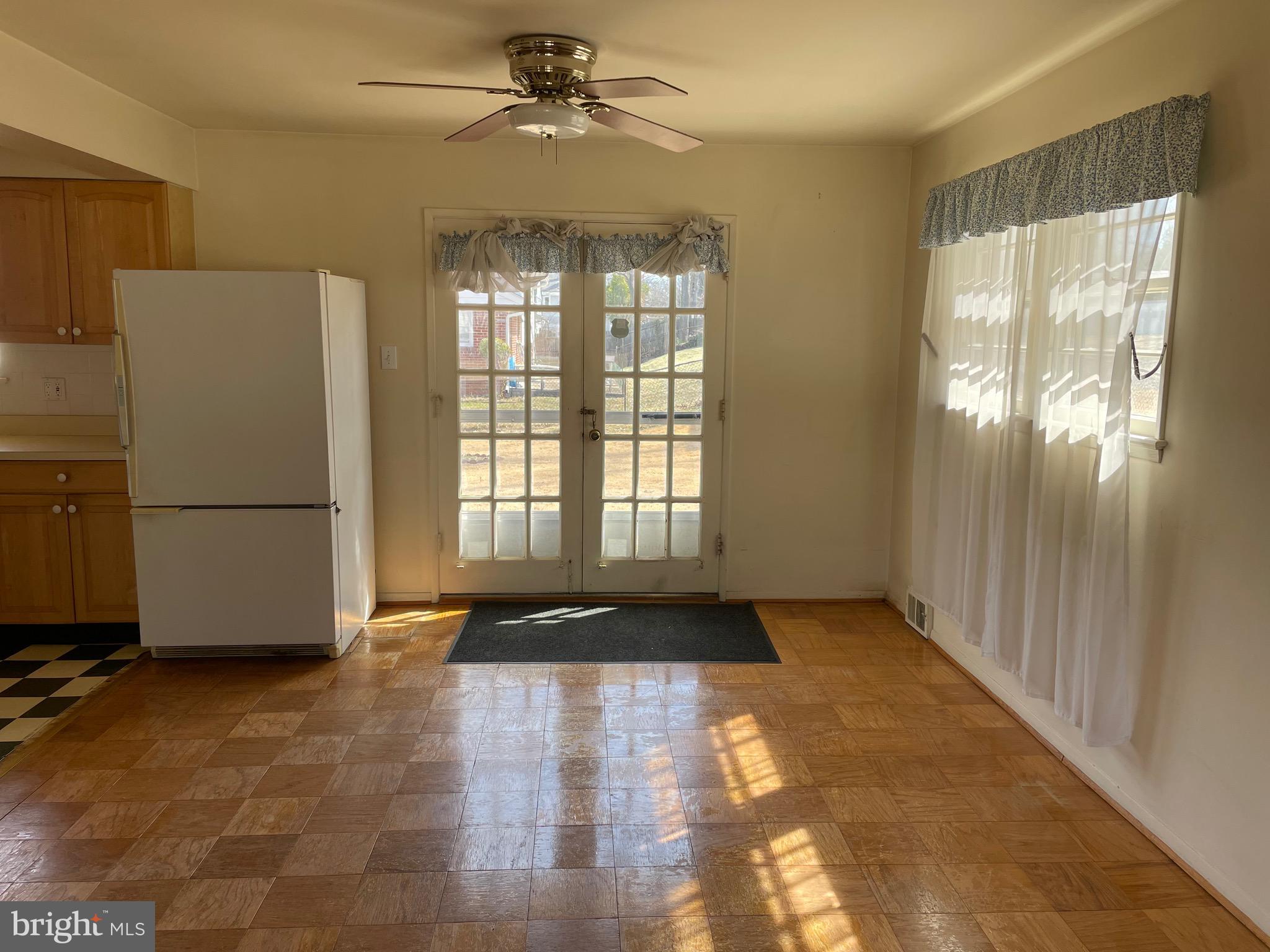 5409 Montgomery Street Springfield, VA 22151 - Photo 6 of 8 a view of an empty room with window and a kitchen