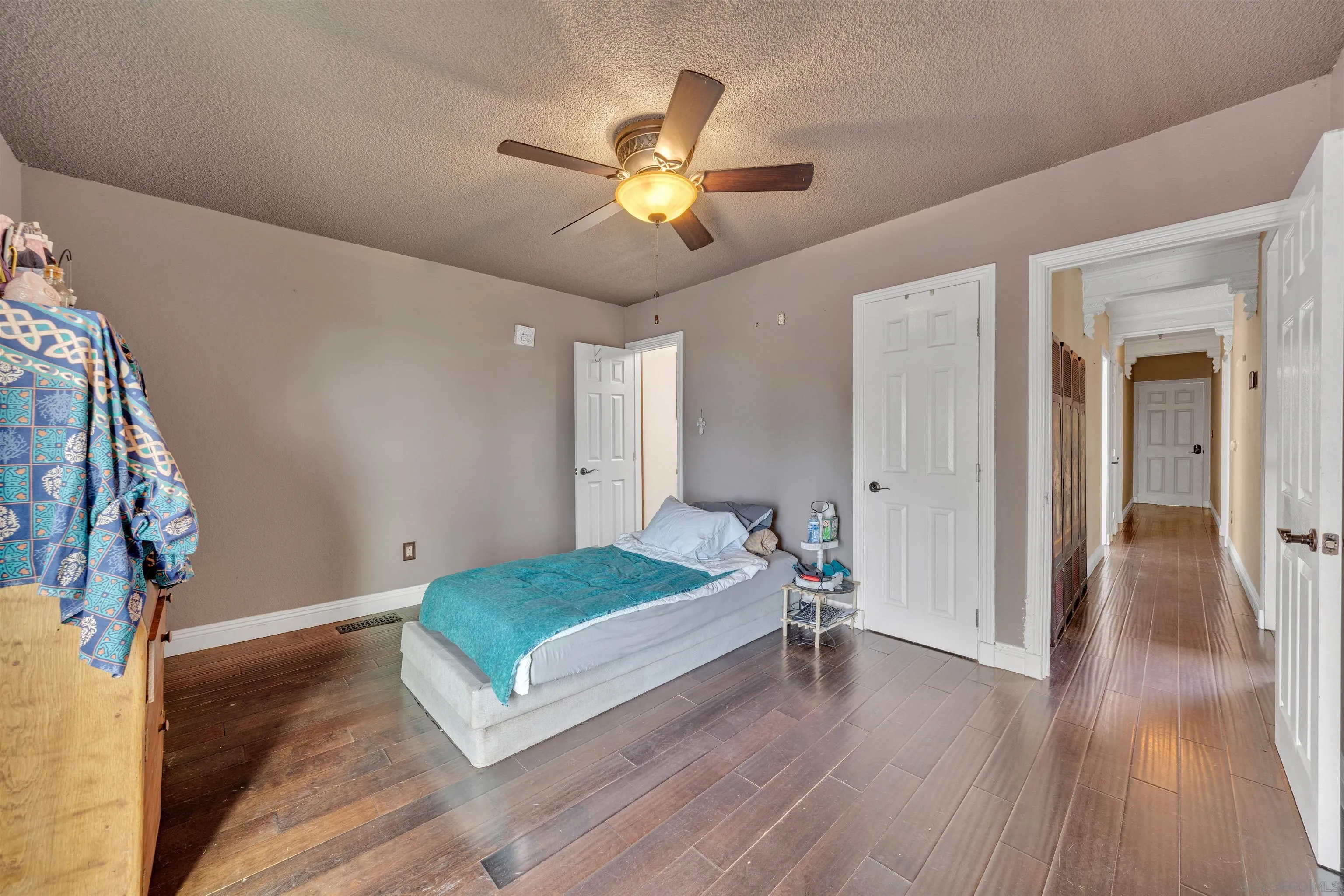 1302 Paraiso Avenue Spring Valley, CA 91977 - Photo 14 of 34 a living room with a bed furniture and a wooden floor