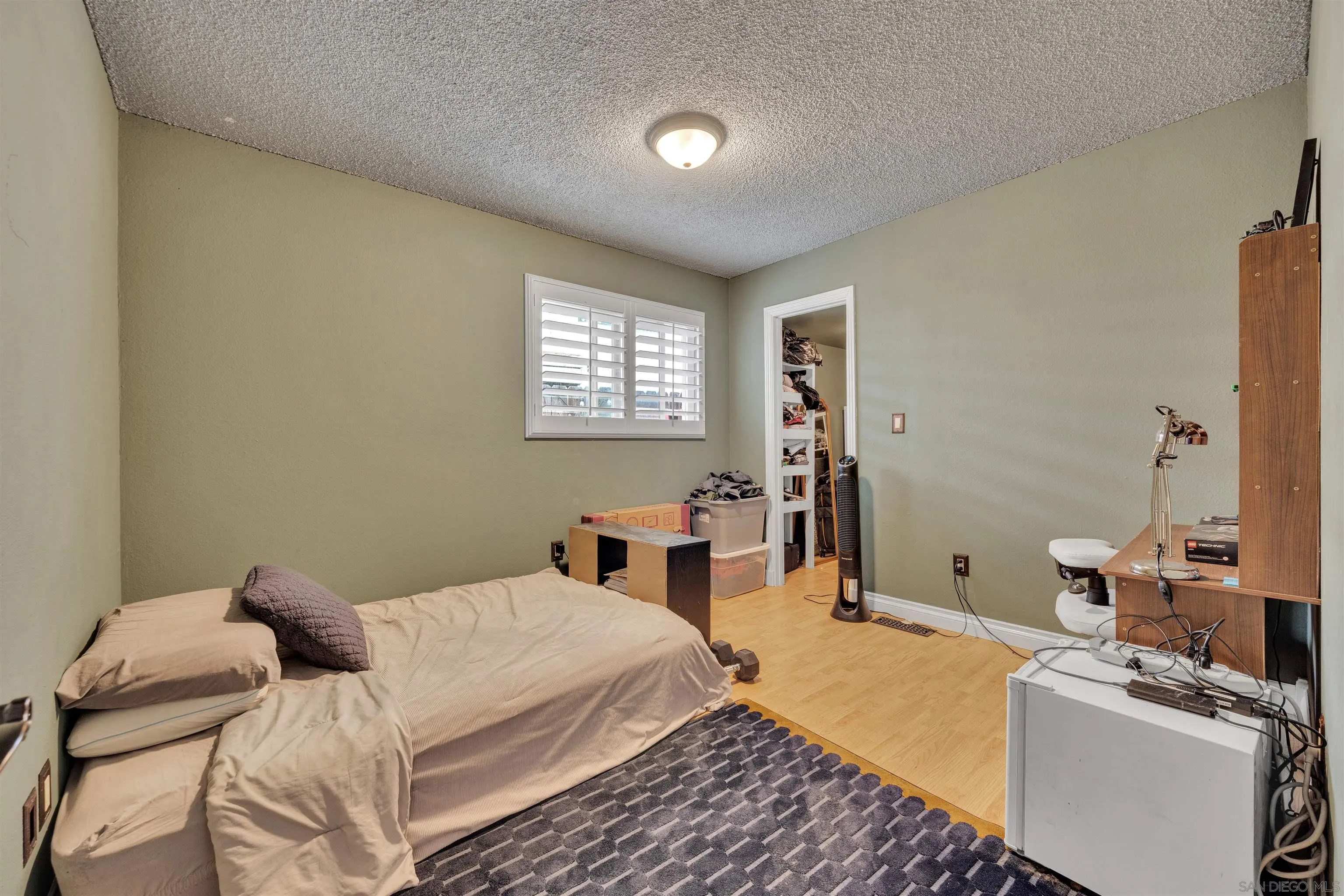 1302 Paraiso Avenue Spring Valley, CA 91977 - Photo 18 of 34 a bedroom with a bed and a table in it