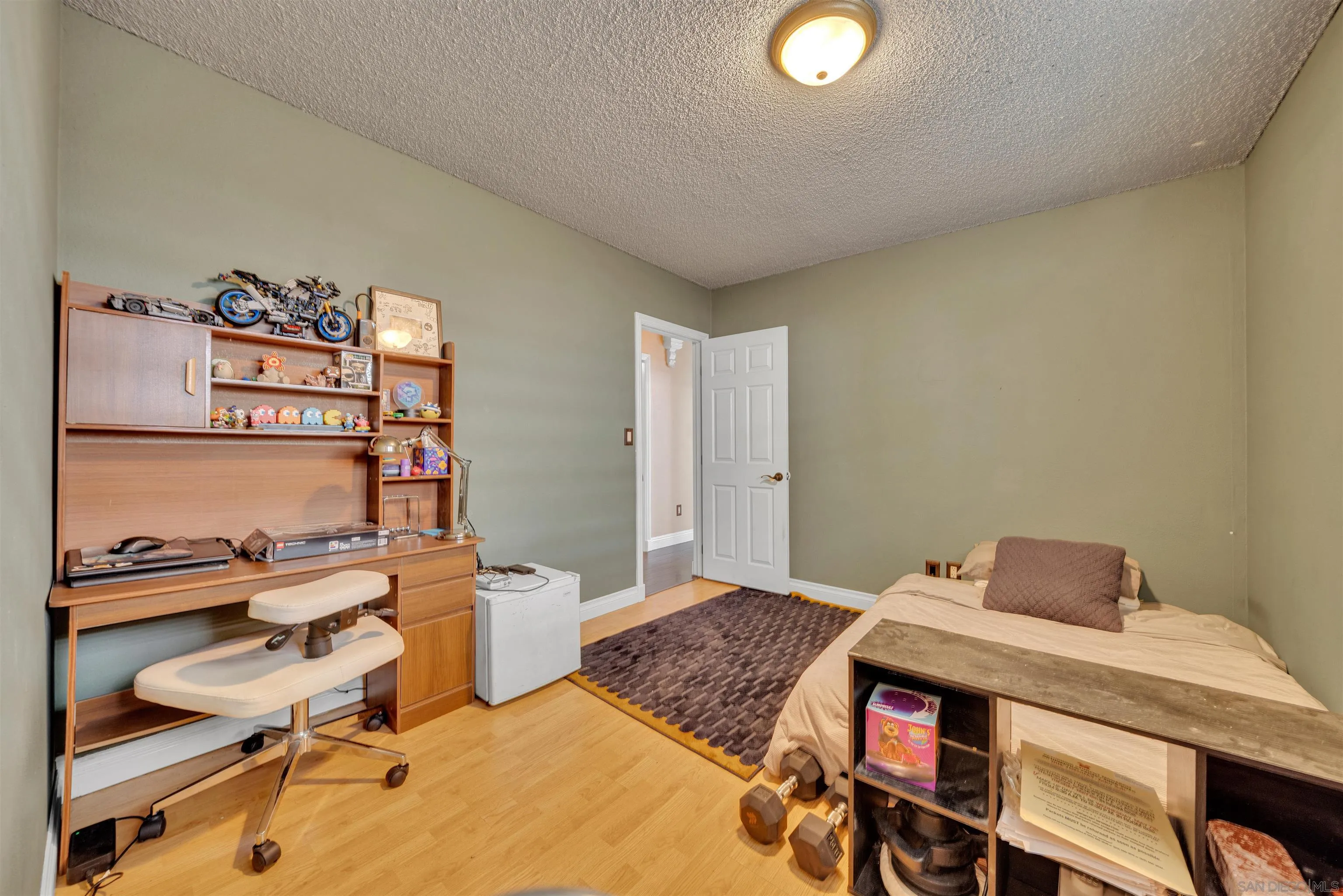 1302 Paraiso Avenue Spring Valley, CA 91977 - Photo 19 of 34 a bedroom with a bed and a desk