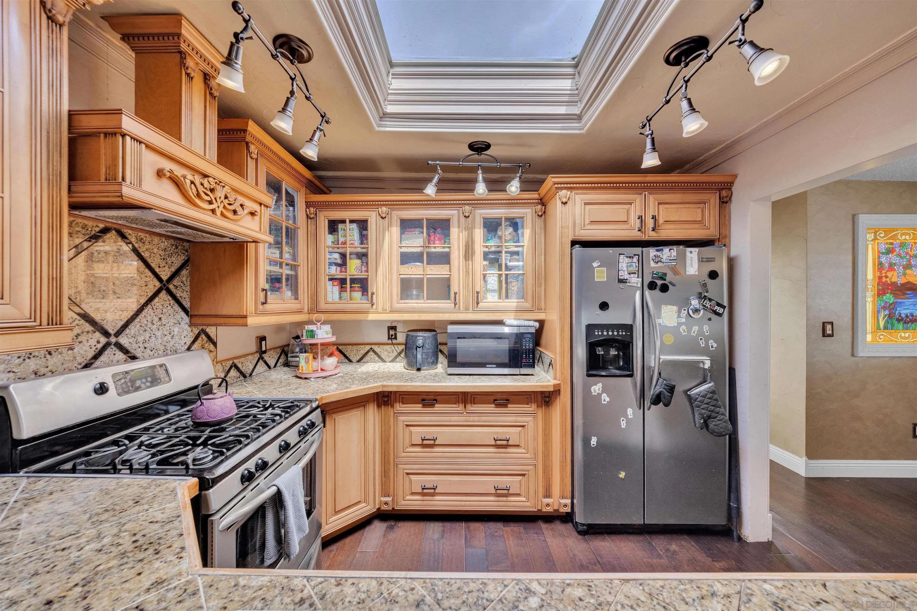 1302 Paraiso Avenue Spring Valley, CA 91977 - Photo 5 of 34 a kitchen with stainless steel appliances granite countertop a stove and a refrigerator
