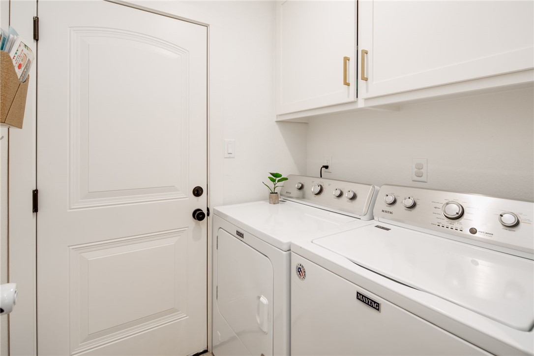 4700 Kensington Road Bryan, TX 77802 - Photo 22 of 31 Dedicated laundry area featuring white cabinetry with gold-tone hardware