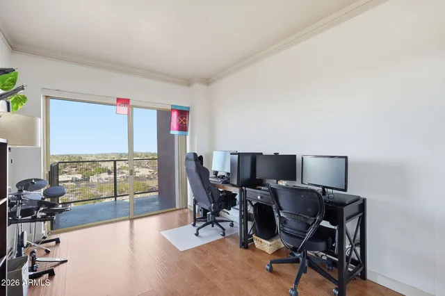 a kitchen with stainless steel appliances granite countertop a refrigerator a sink dishwasher a stove and a dining table with wooden floor