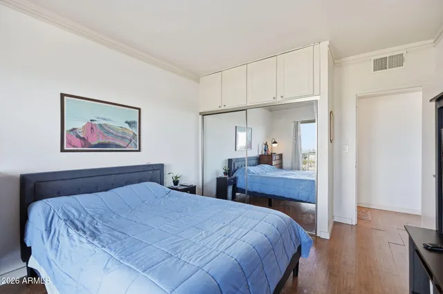 a bedroom with furniture and a flat screen tv