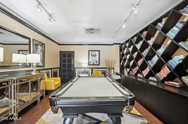 a living room with a table chairs and a kitchen view