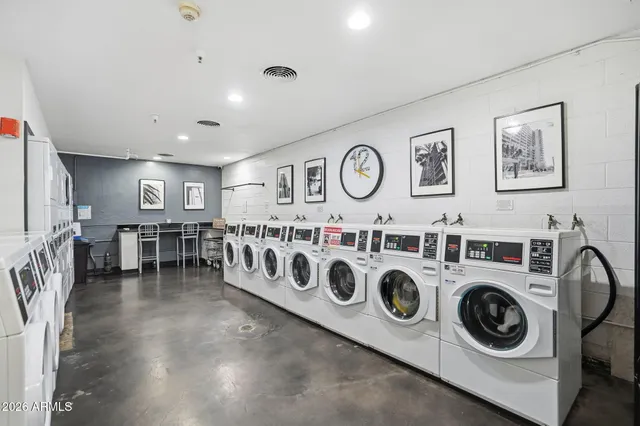 a view of a patio with a dining table and chairs with plants