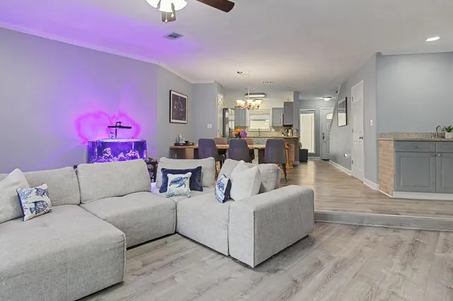 a living room with furniture and a chandelier
