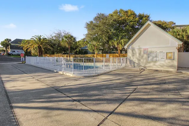 a view of a house with backyard and trees