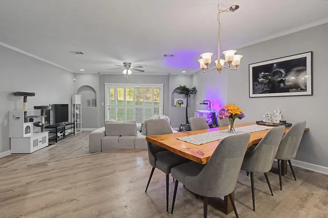 a view of a dining room with furniture window and wooden floor