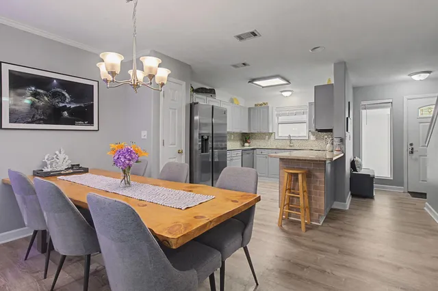 a view of a dining room with furniture and wooden floor