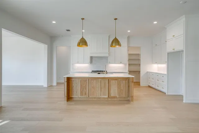 a view of kitchen with stainless steel appliances granite countertop a sink a stove and a window