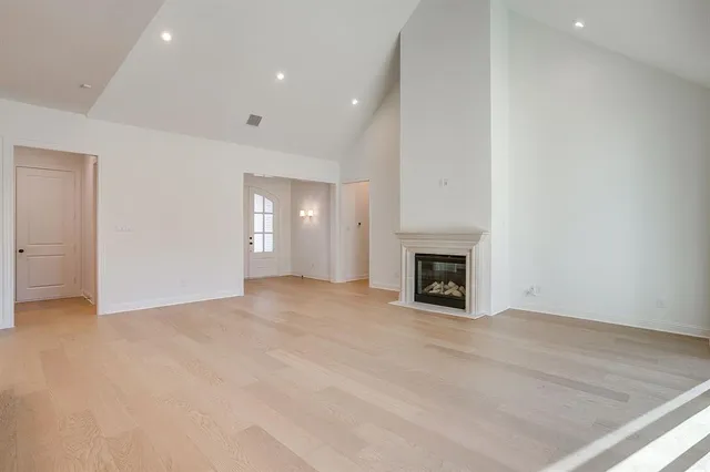 a view of an empty room with a fireplace
