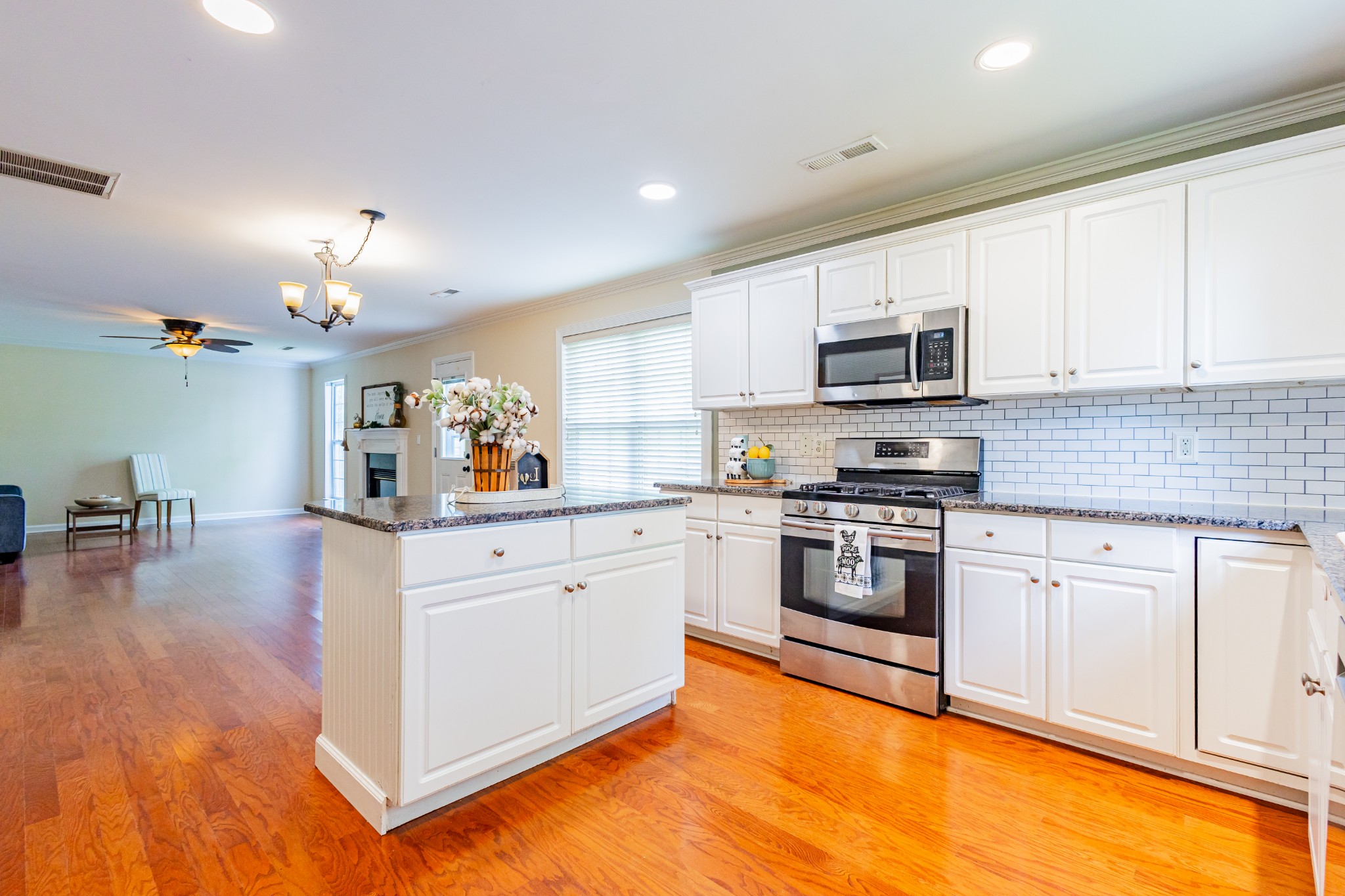 2236 Hayward Lane Spring Hill, TN 37174 - Photo 11 of 59 a kitchen with stainless steel appliances granite countertop a stove top oven a sink dishwasher and a refrigerator with wooden floor