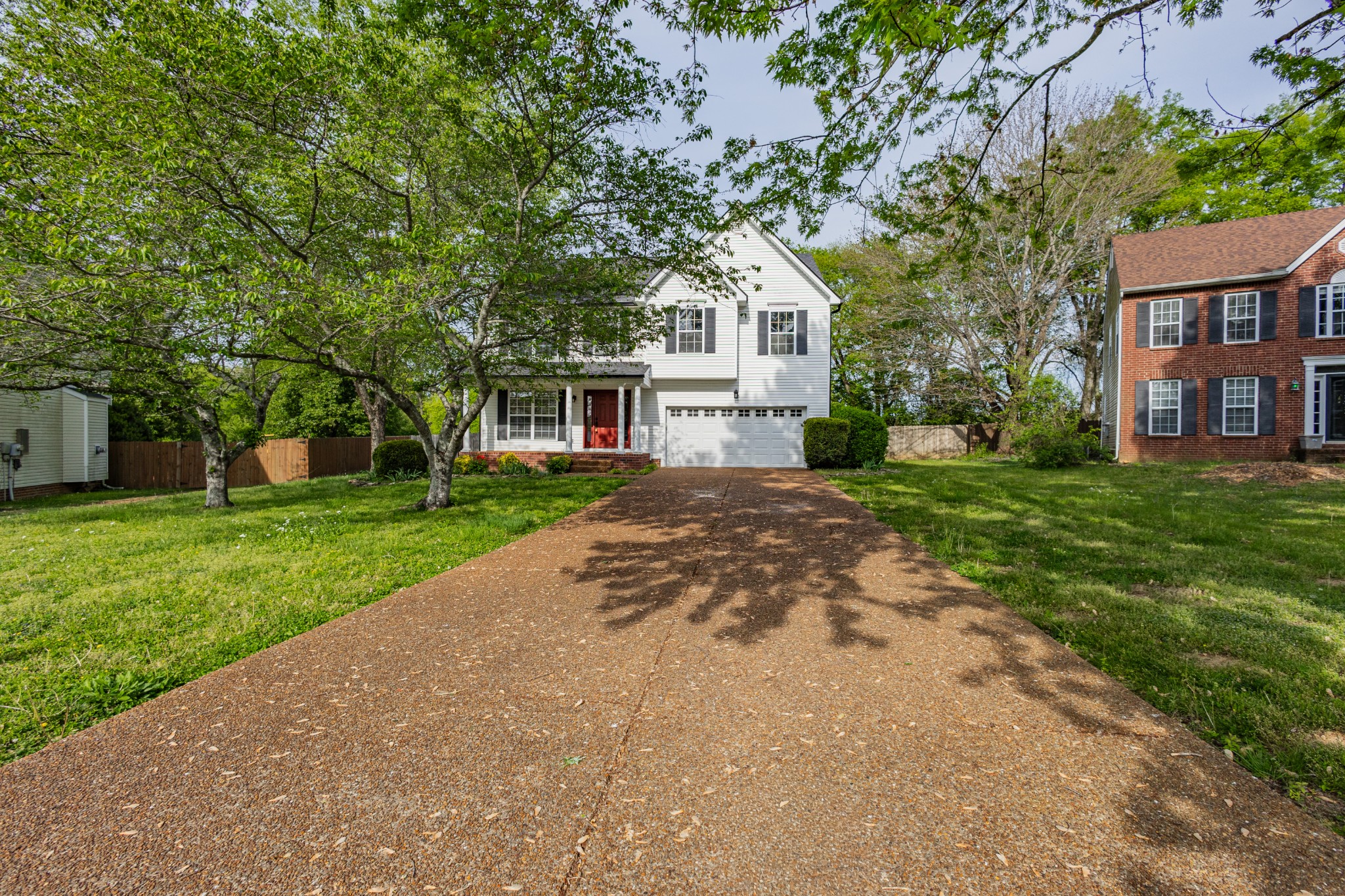 2236 Hayward Lane Spring Hill, TN 37174 - Photo 2 of 59 a view of a white house next to a yard with big trees