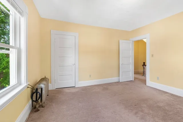 a view of a room with a door and a window