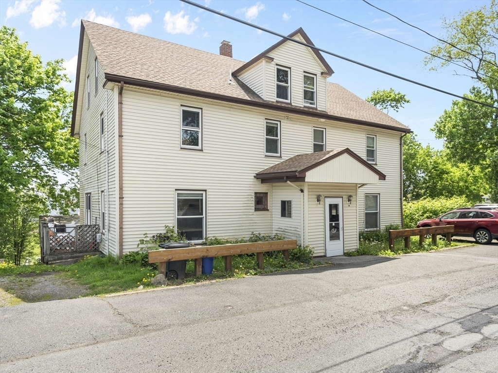 12 Folger Avenue, Unit 3 Beverly, MA 01915 - Photo 20 of 20 a front view of a house with a yard and a garage
