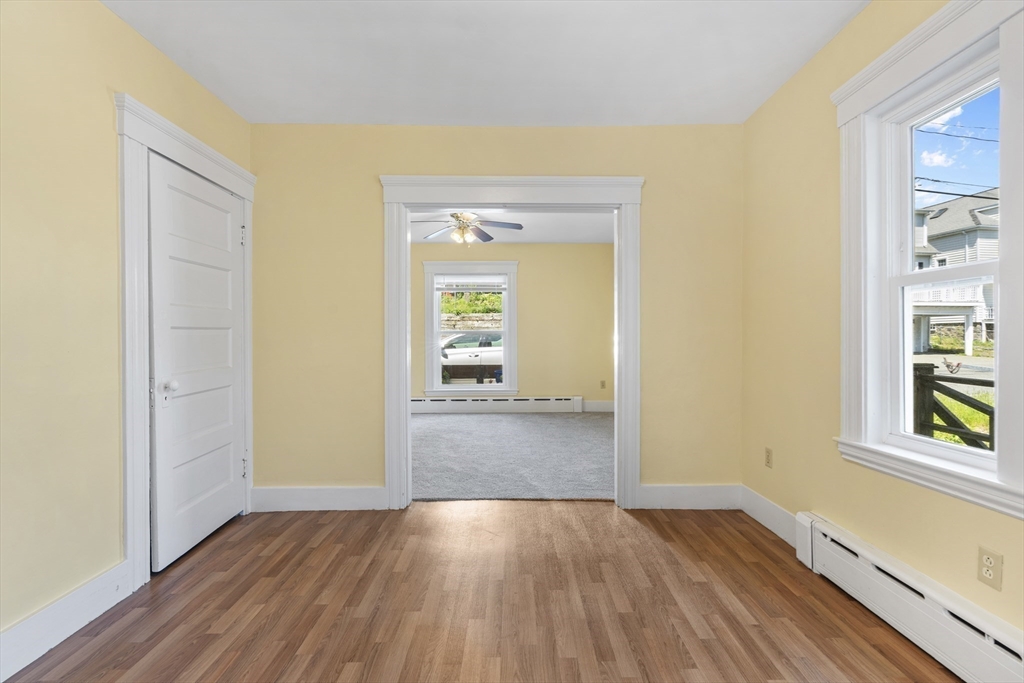 12 Folger Avenue, Unit 3 Beverly, MA 01915 - Photo 4 of 20 an empty room with wooden floor and windows