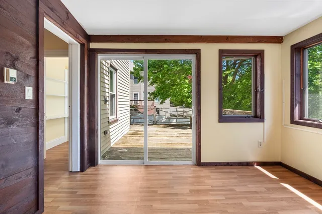 a view of front door and porch with wooden floor