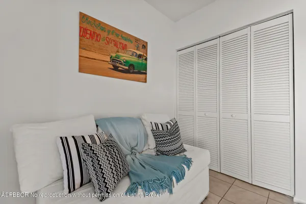 a bedroom with a bed and a painting on the wall
