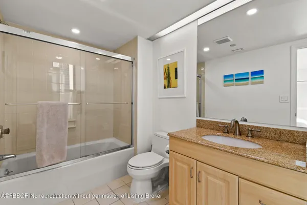 a dining room with furniture and a potted plant