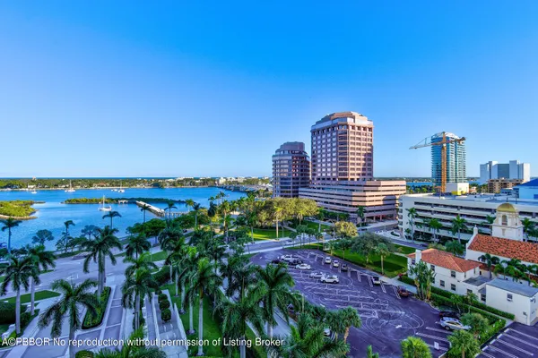 a dining hall with stainless steel appliances granite countertop a dining table and chairs
