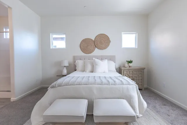 a bedroom with a bed and window