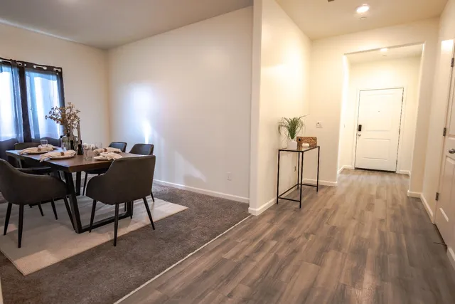 a view of a room with furniture and wooden floor