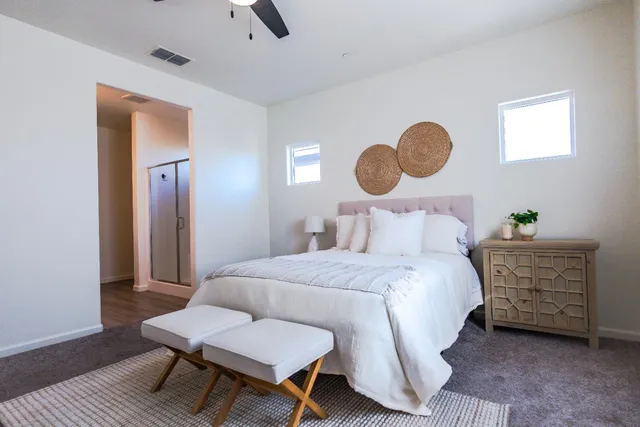 a bedroom with a bed and a chandelier