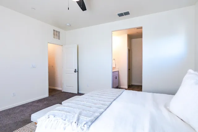 a bedroom with a bed and a dresser