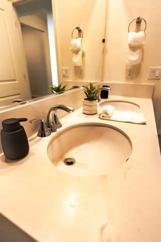 a bathroom with a double vanity sink and a mirror