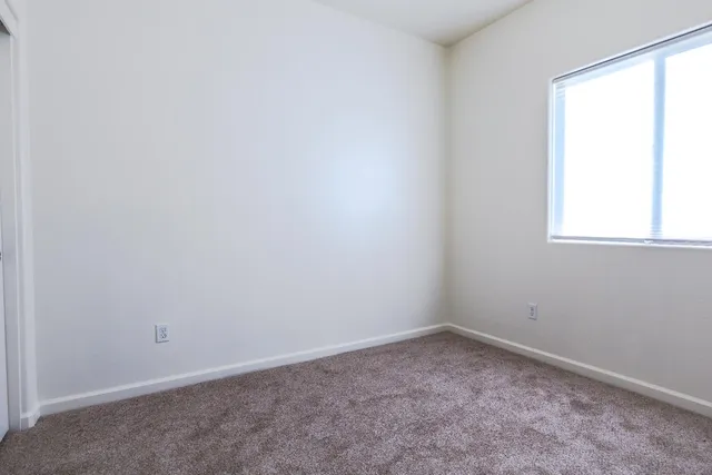an empty room with closet area