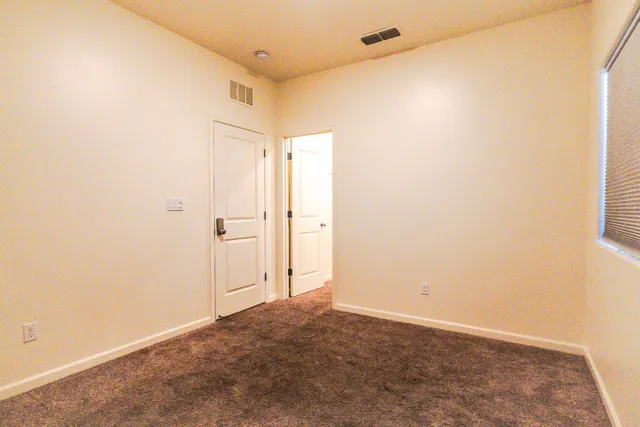 a view of a backyard with wooden fence