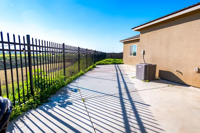 a view of a balcony with floor to ceiling windows with wooden fence