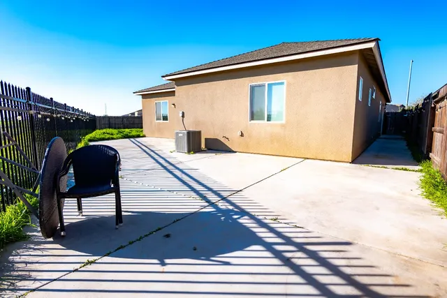 a view of a backyard with wooden fence