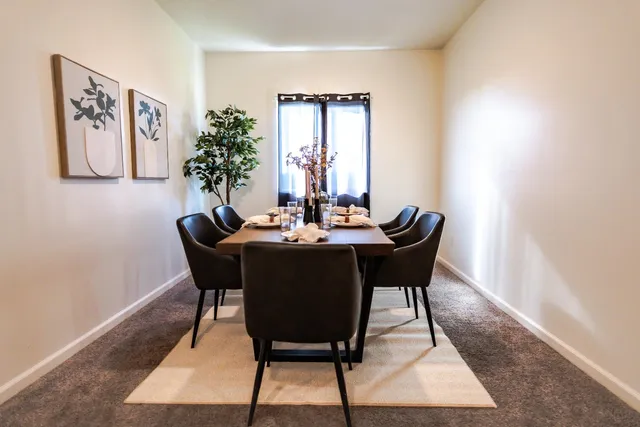 a dining room with furniture and window